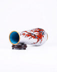 Close-up detail of the gold-plated copper rim and enamel red plum pillar pattern on this Royal Cloisonne vase,a premium piece for luxury home decor and home gifts